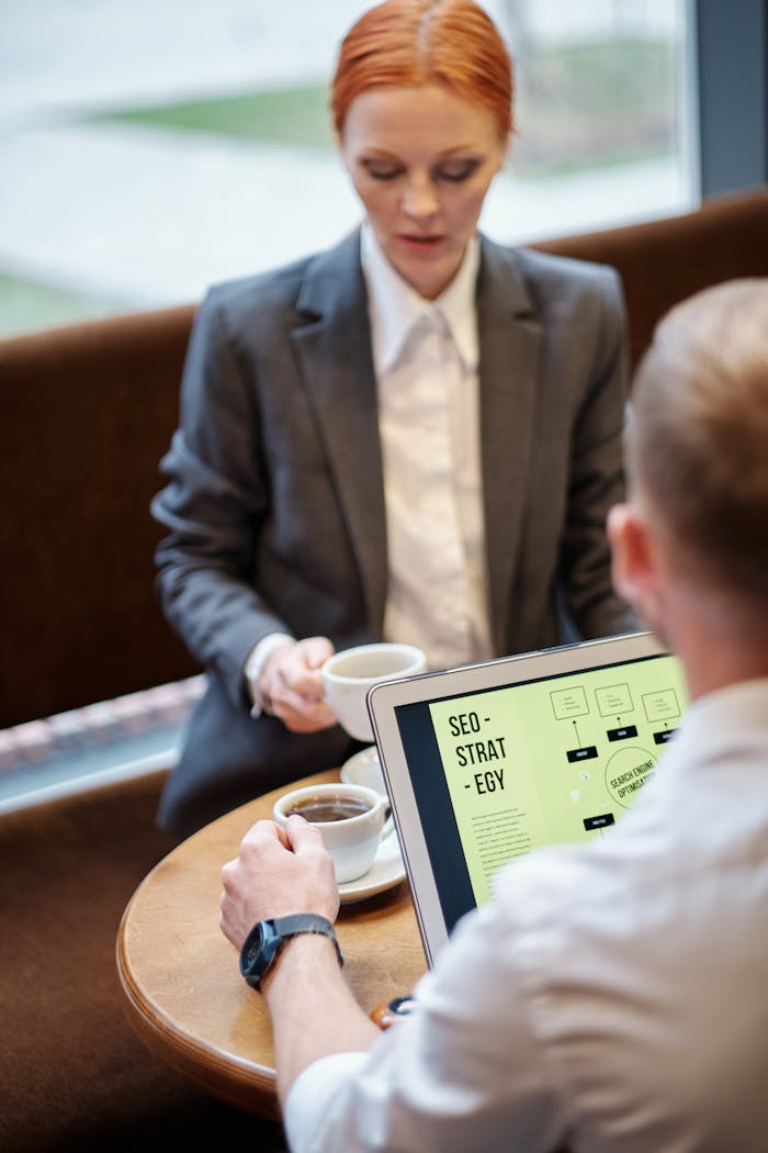 services-02 Professional meeting in a café with a laptop showcasing an SEO strategy. Ideal for business concepts.